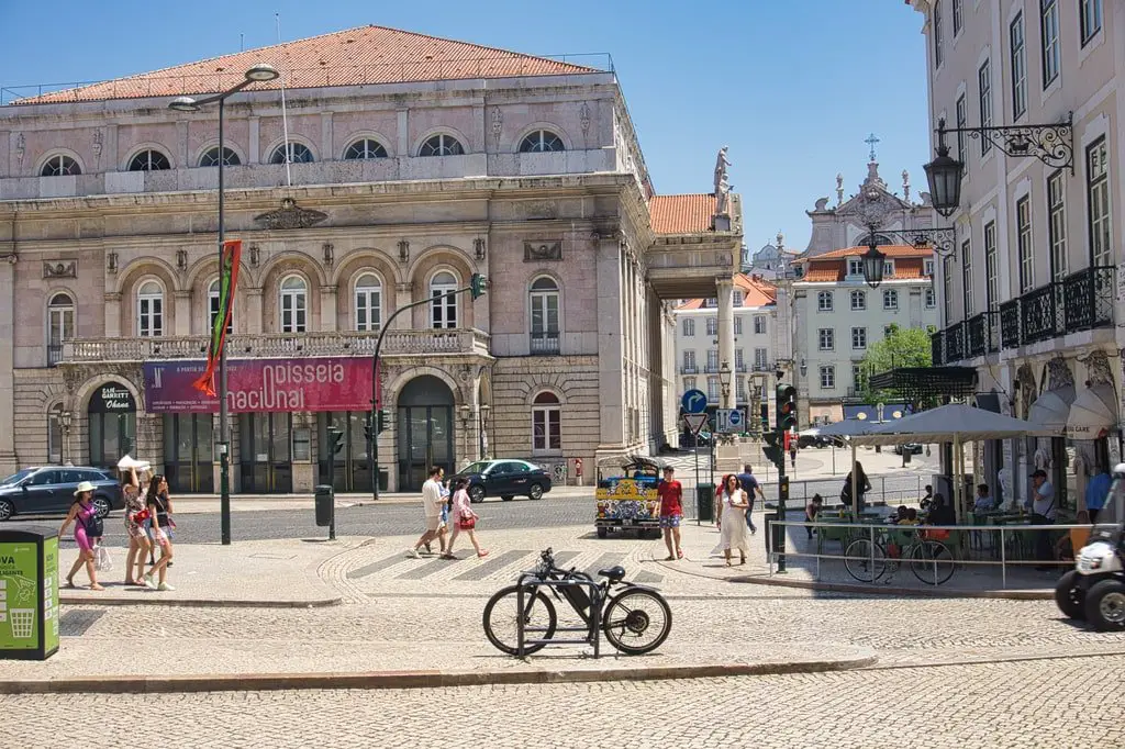 A bicycle is parked in a central square in Lisbon.
