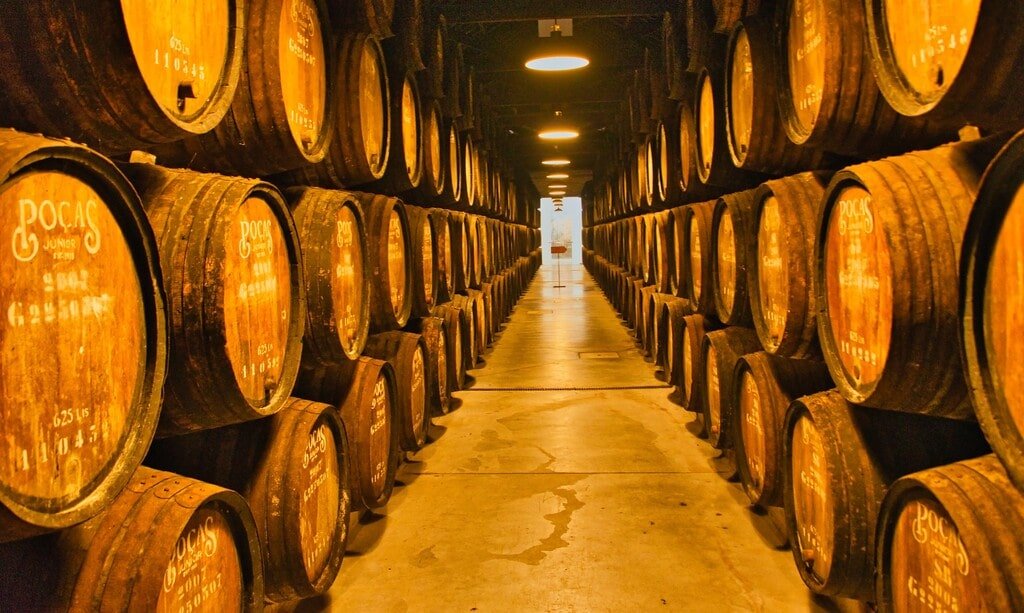 the corridor flanked by barrels inside the Pocas winery of Villa Nova de Gaia.