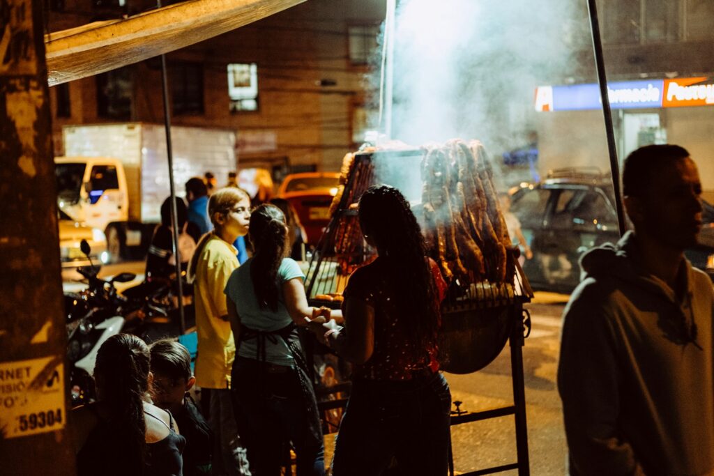 a group of people standing around a bbq