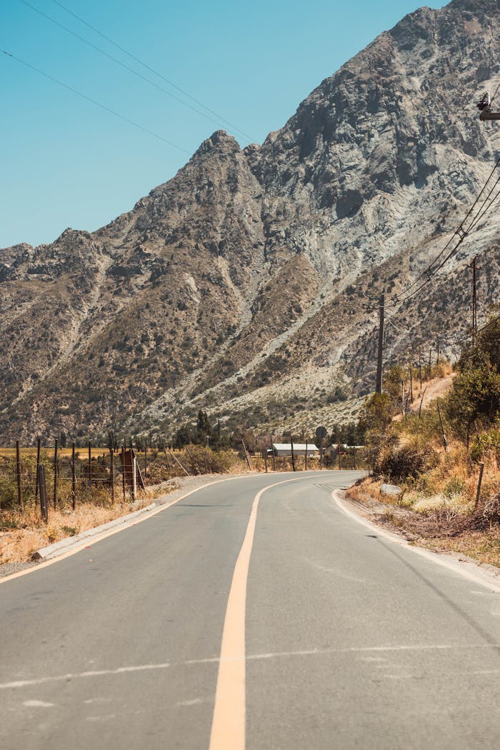 Peaceful road through the mountains in Maipú, Chile, ideal for road trips and travel photography.