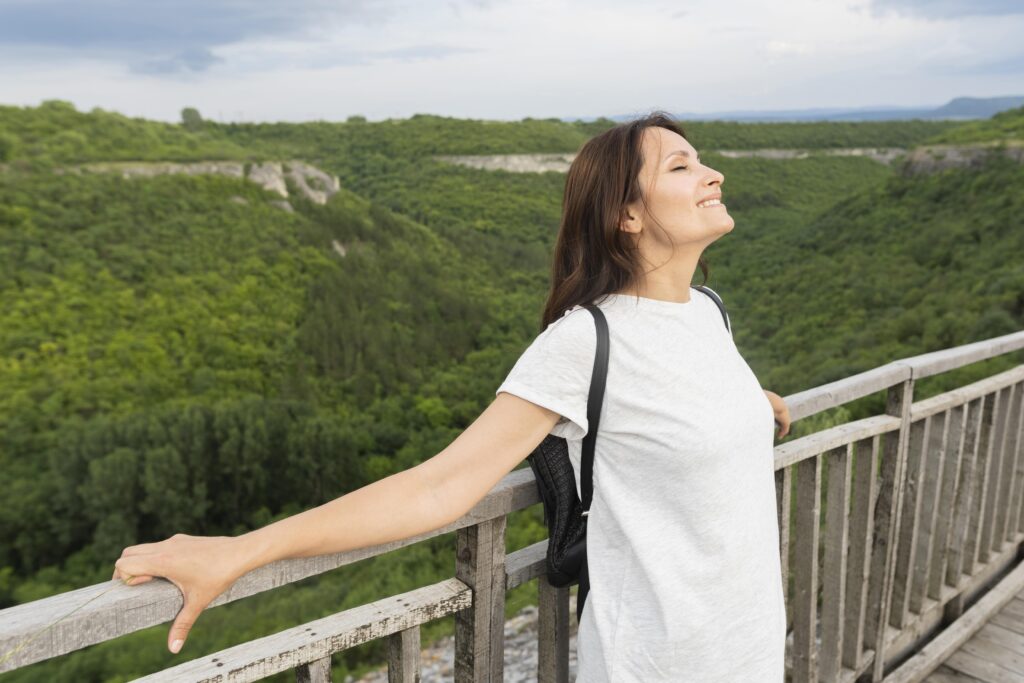 side-view-woman-bridge-enjoying-nature