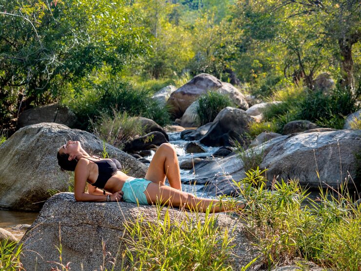 side-view-young-woman-lying-rock_1048944-6509233